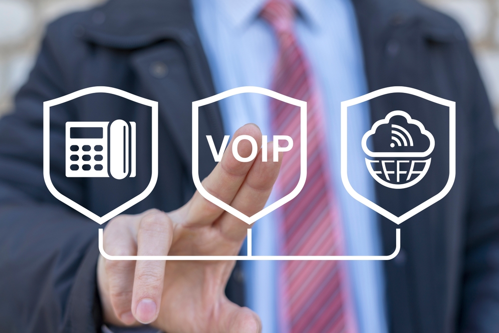 Businessman using virtual touch screen presses abbreviation: VOIP