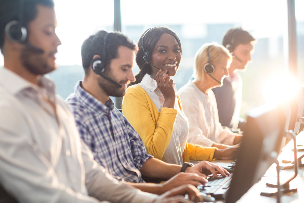 Team working on computers with headsets