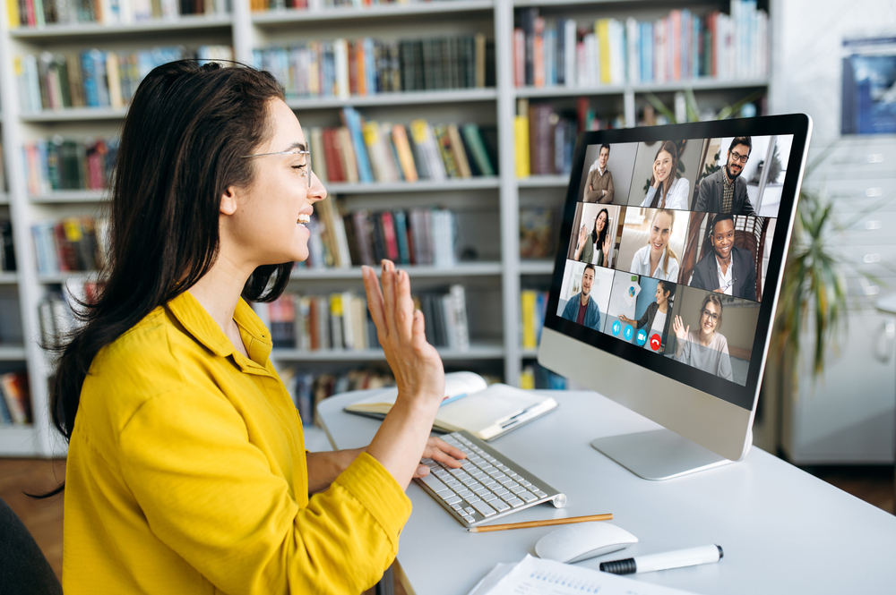 Remote worker on a video conference call using a desktop computer from home office
